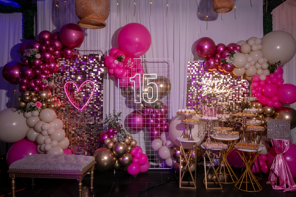 Elegant quinceañera décor setup with pink and gold theme